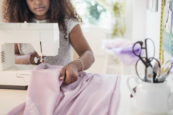 black-woman-using-sewing-machine-606353381-5bd0ab47c9e77c00510390e8